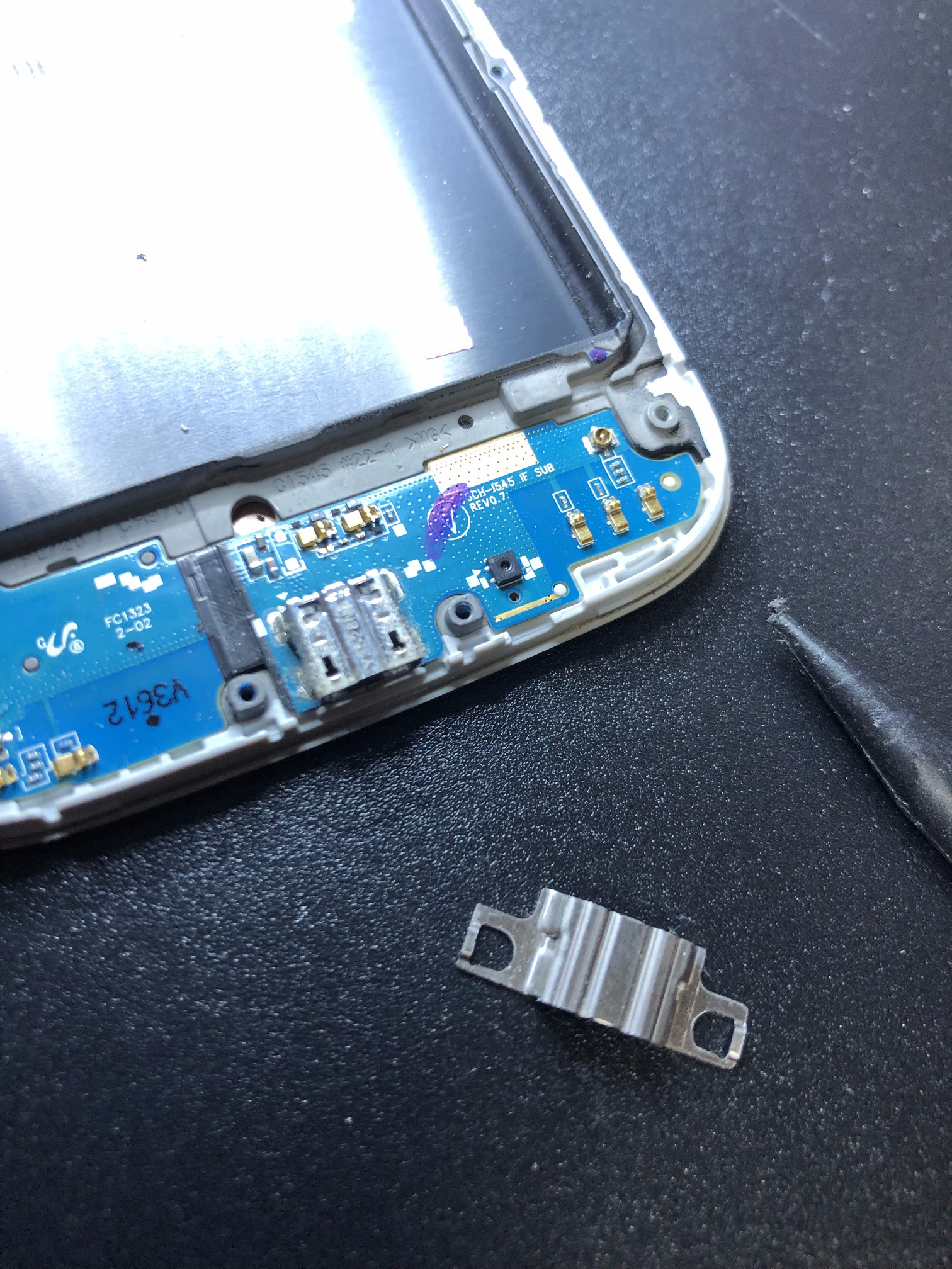 Remove the USB charging port cover using a spudger